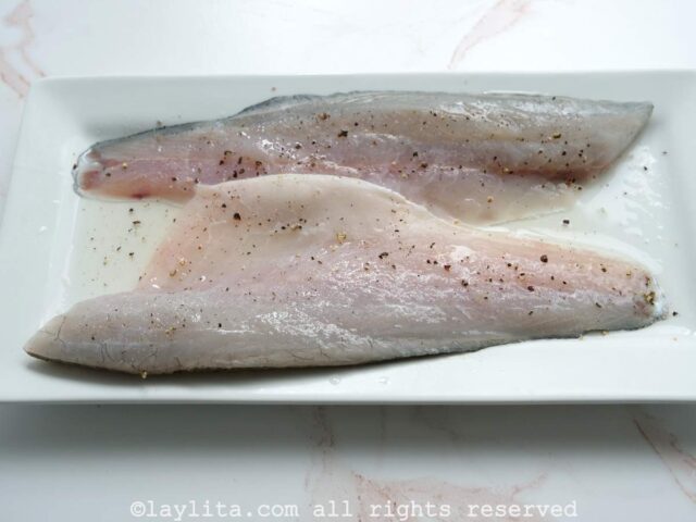 Preparing the fish filets for sudado de pescado fish stew