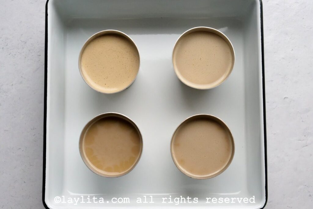 Flan mixture distributed into four small ramekins.