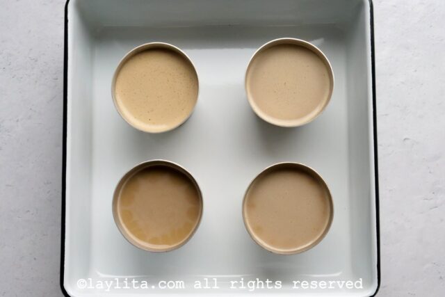 Flan mixture distributed into four small ramekins.