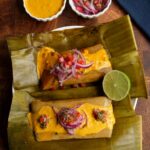 Photos of two Ecuadorian fish bollos or plantain tamales topped with peanut sauce and pickled onions