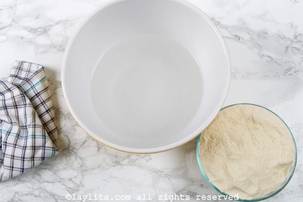 Ingredients to make arepa corn dough on a kitchen counter