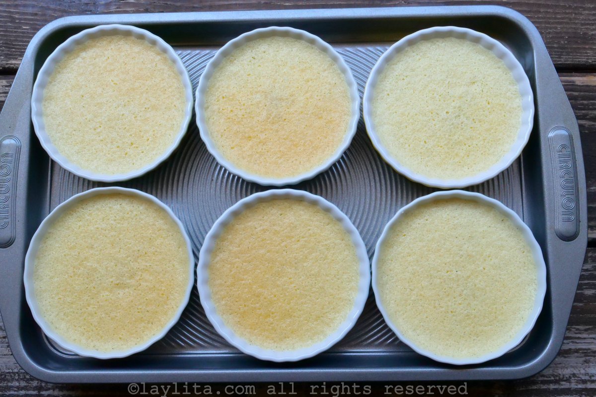 Overhead shot of two ramekins of creme brulee after they have been baked but before there is a layer of burnt sugar on top.