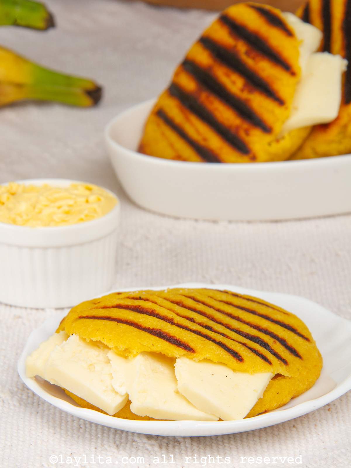 A plate with a ripe plantain arepa filled with cheese