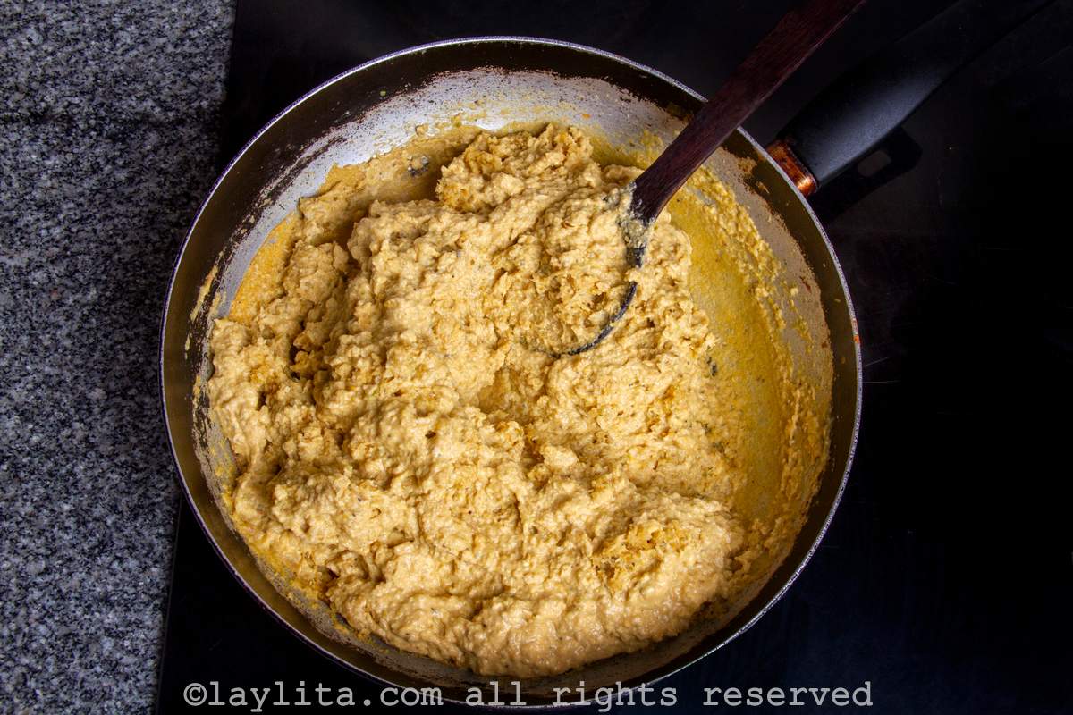 Green plantain dough cooking in a pan