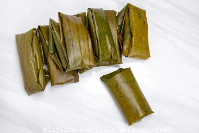 Bollos in the plantain leaves after being rolled and folded up