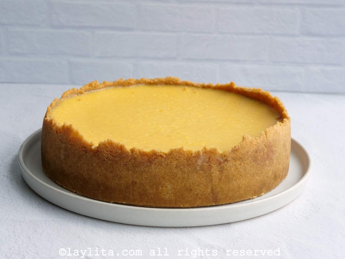 Passion fruit cheesecake on a plate with no sauce on top.