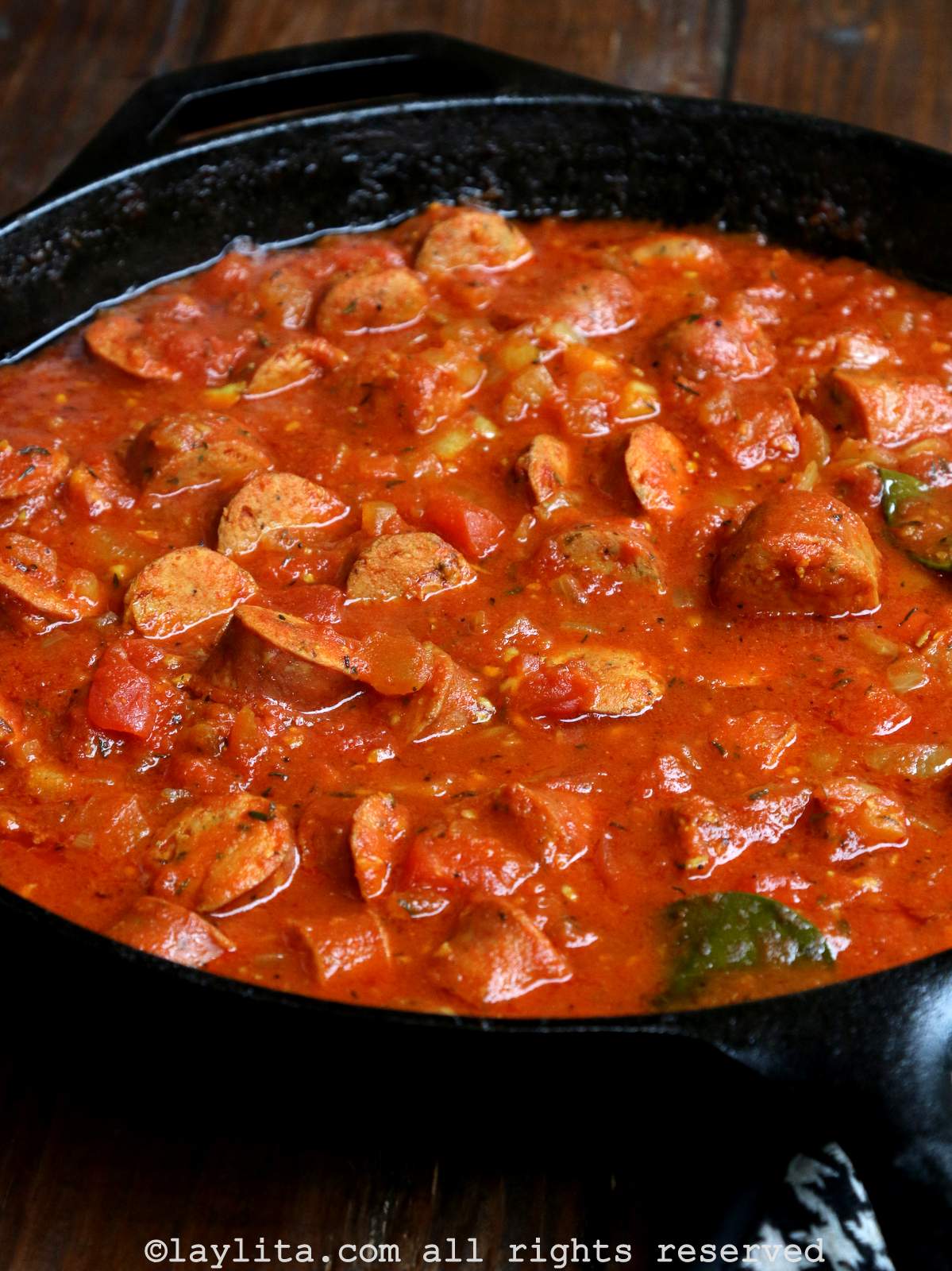Close up of sausage rougail stew or rougaille saucisse in a cast iron pan.
