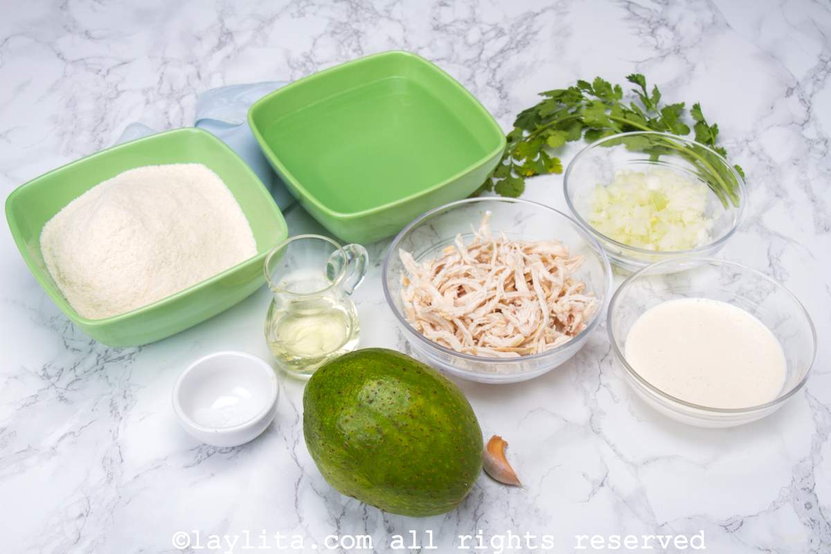 Ingredients needed for chicken avocado stuffed arepas on a kitchen counter.