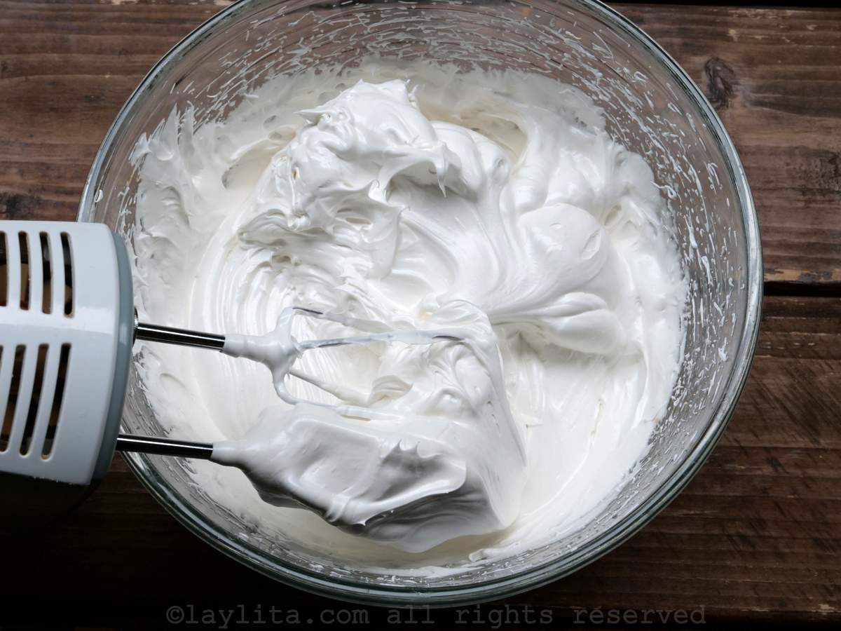 Using a electric hand mixer to whisk together the eggs and sugar.