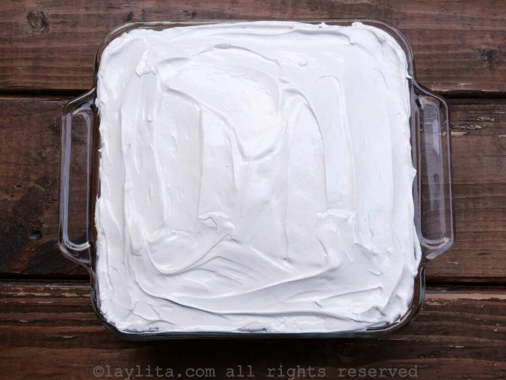 Overhead shot of tres leches cake decorated with white swiss meringue