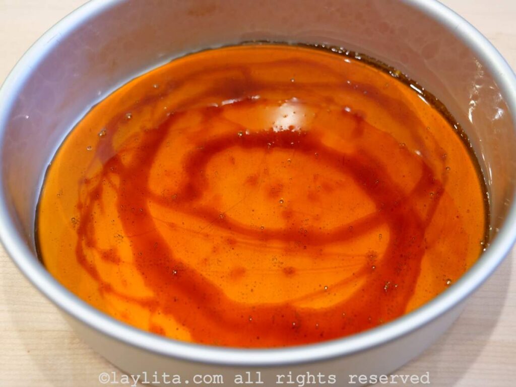 A cake pan coated with caramel for flan