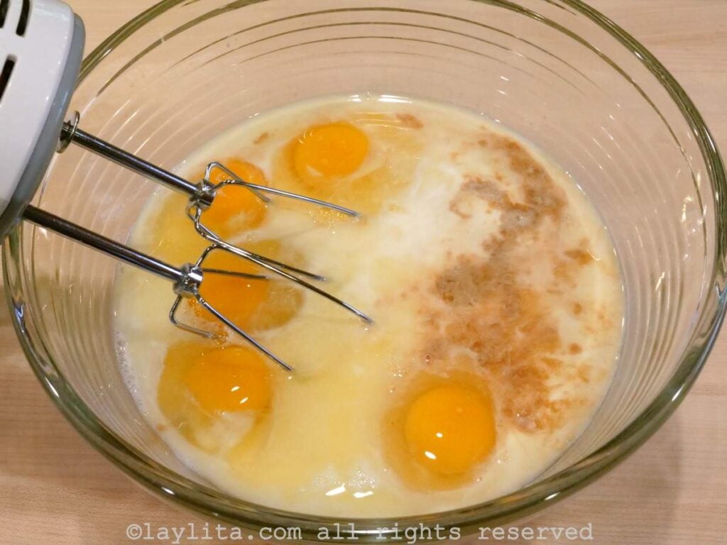 Ingredients for quesillo in a mixing bowl before being whisked together.