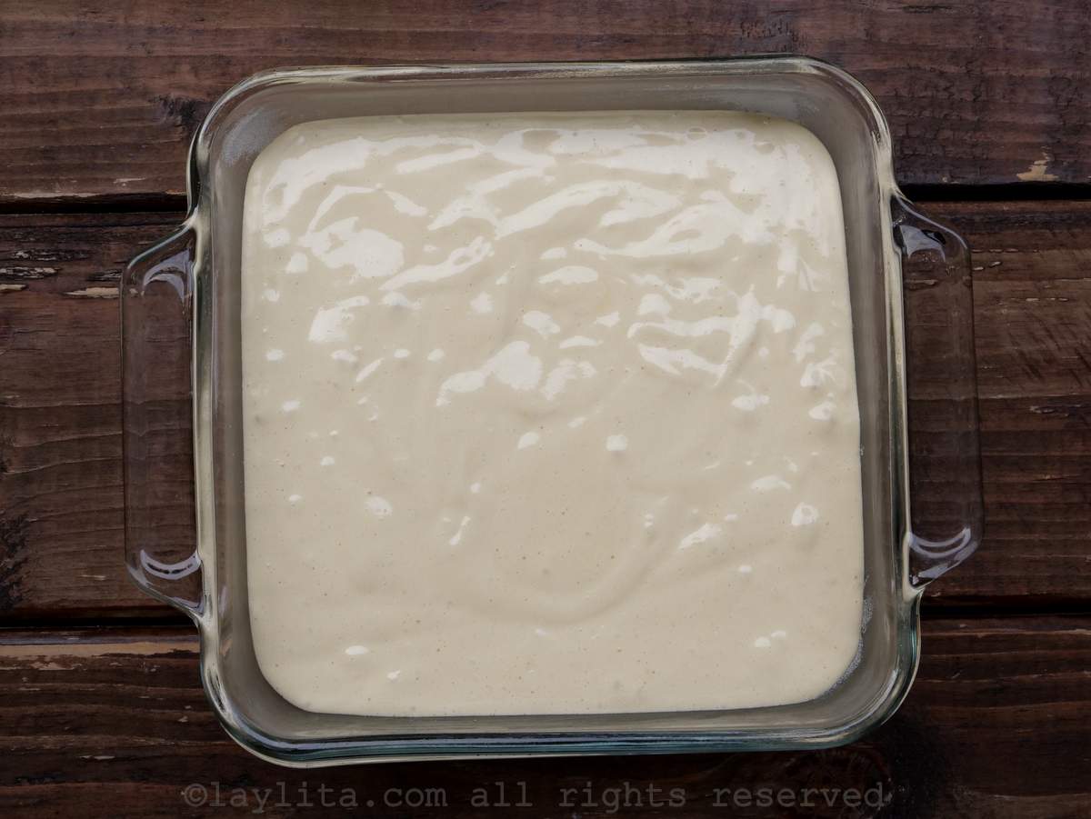 Cake batter in a prepared glass baking dish.
