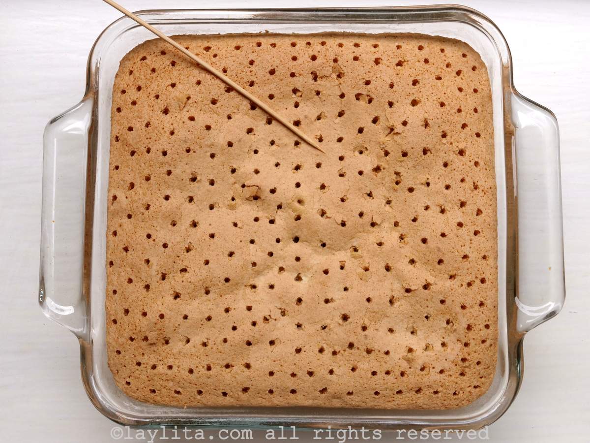 Overhead shot of baked cake with holes in the top.