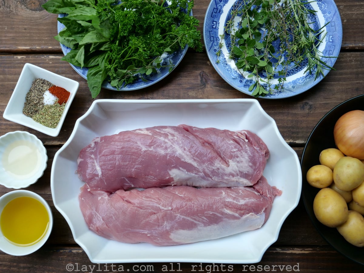 Ingredients needed for roasted pork tenderloin and garlic herb chimichurri marinade: pork tenderloins, garlic, parsley, oregano, thyme, olive oil, cider vinegar, paprika, salt/pepper, and baby potatoes/onions.