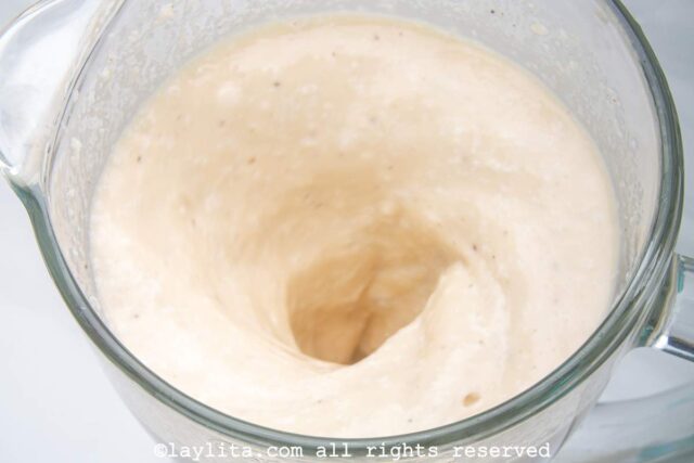 Coquito ingredients in a blender after blending.