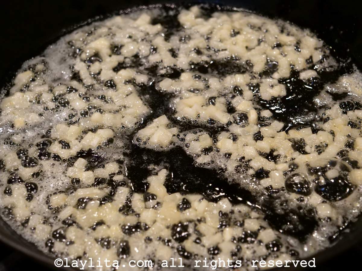 Garlic cooking in a large skillet.