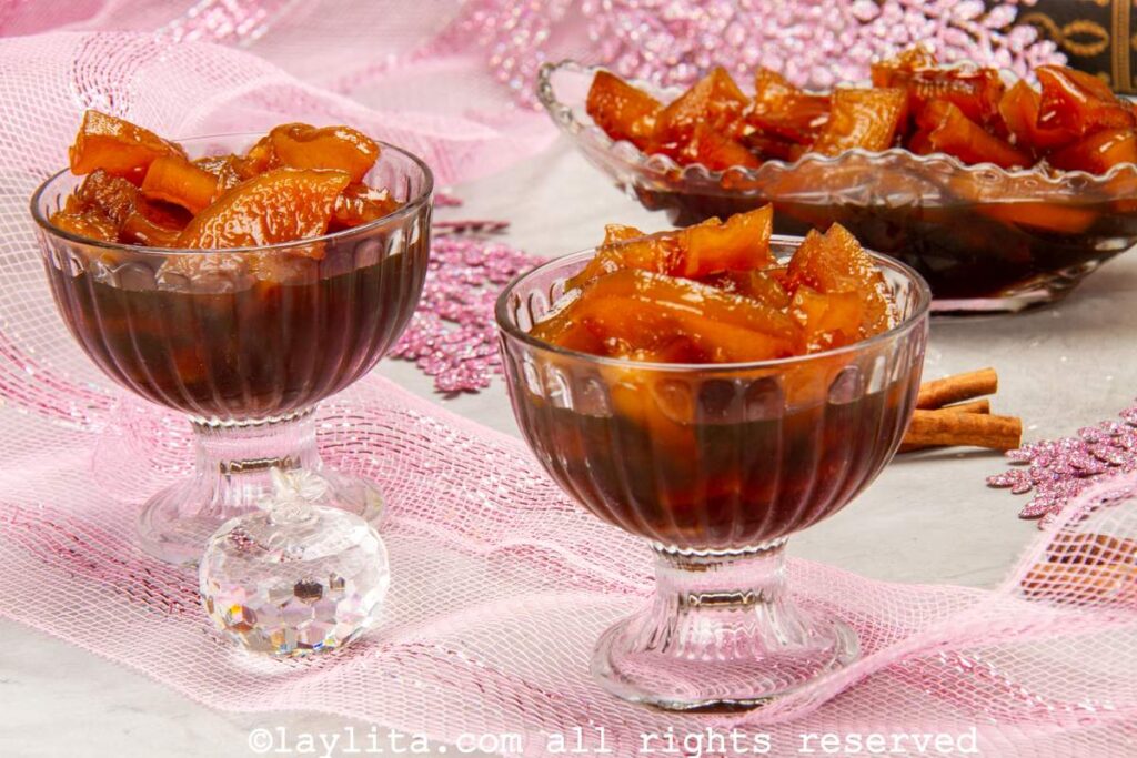 Two small glass dessert bowls filled with candied green papaya preserves or dulce de lechosa