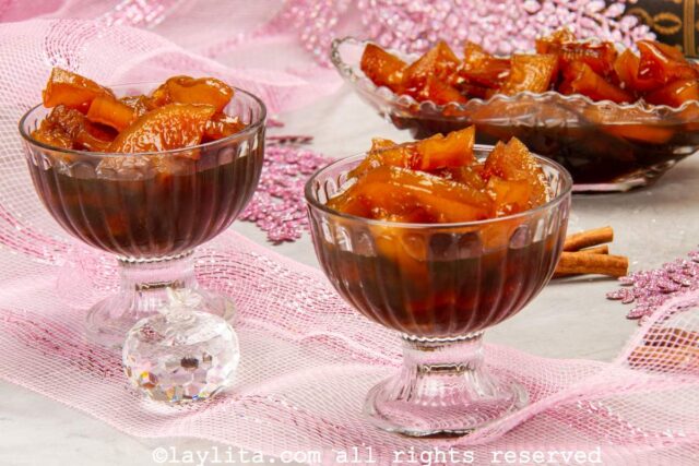 Two small glass dessert bowls filled with candied green papaya preserves or dulce de lechosa