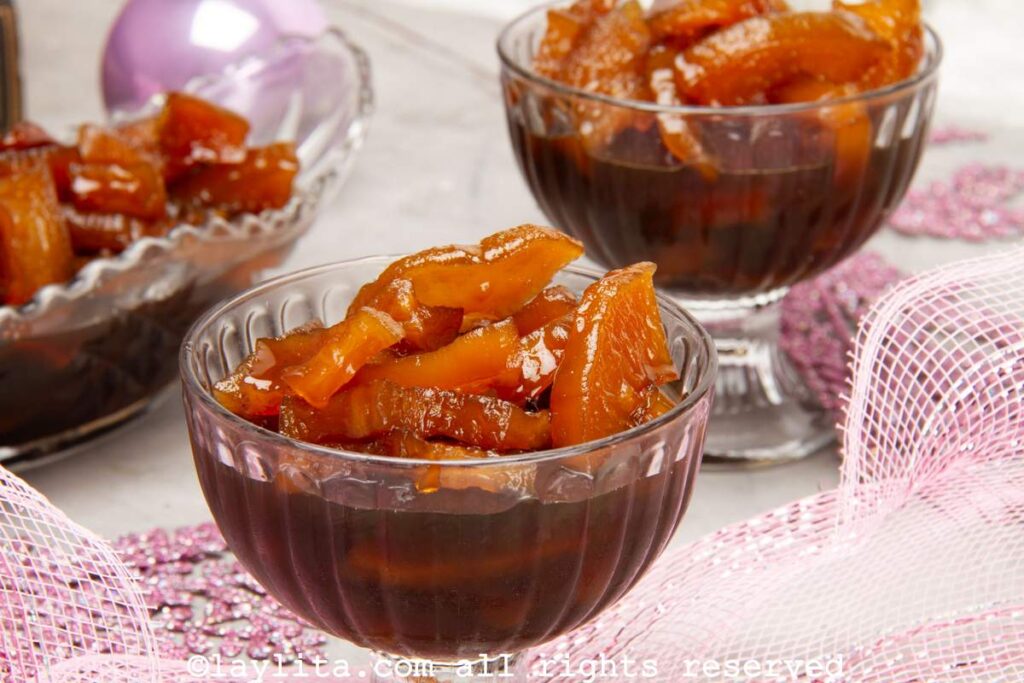 Dulce de Lechosa or Candied Green Papaya in a glass bowl with more in the background
