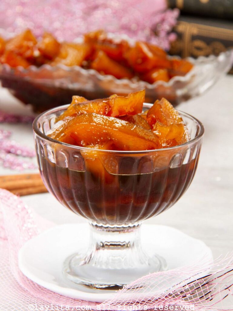 Dulce de lechosa or green papaya preserves served in a small glass dessert bowl