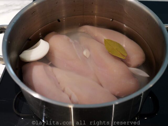 Chicken breasts in a pot covered with watered