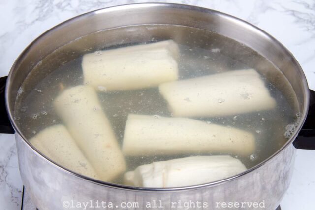 Pieces of yuca cooking in a large stock pot.