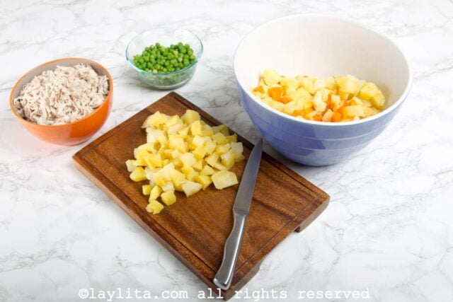 Diced potatoes on a wooden cutting board