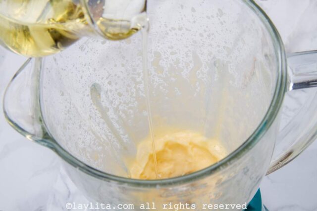 Making mayonnaise in the blender with oil being drizzled in