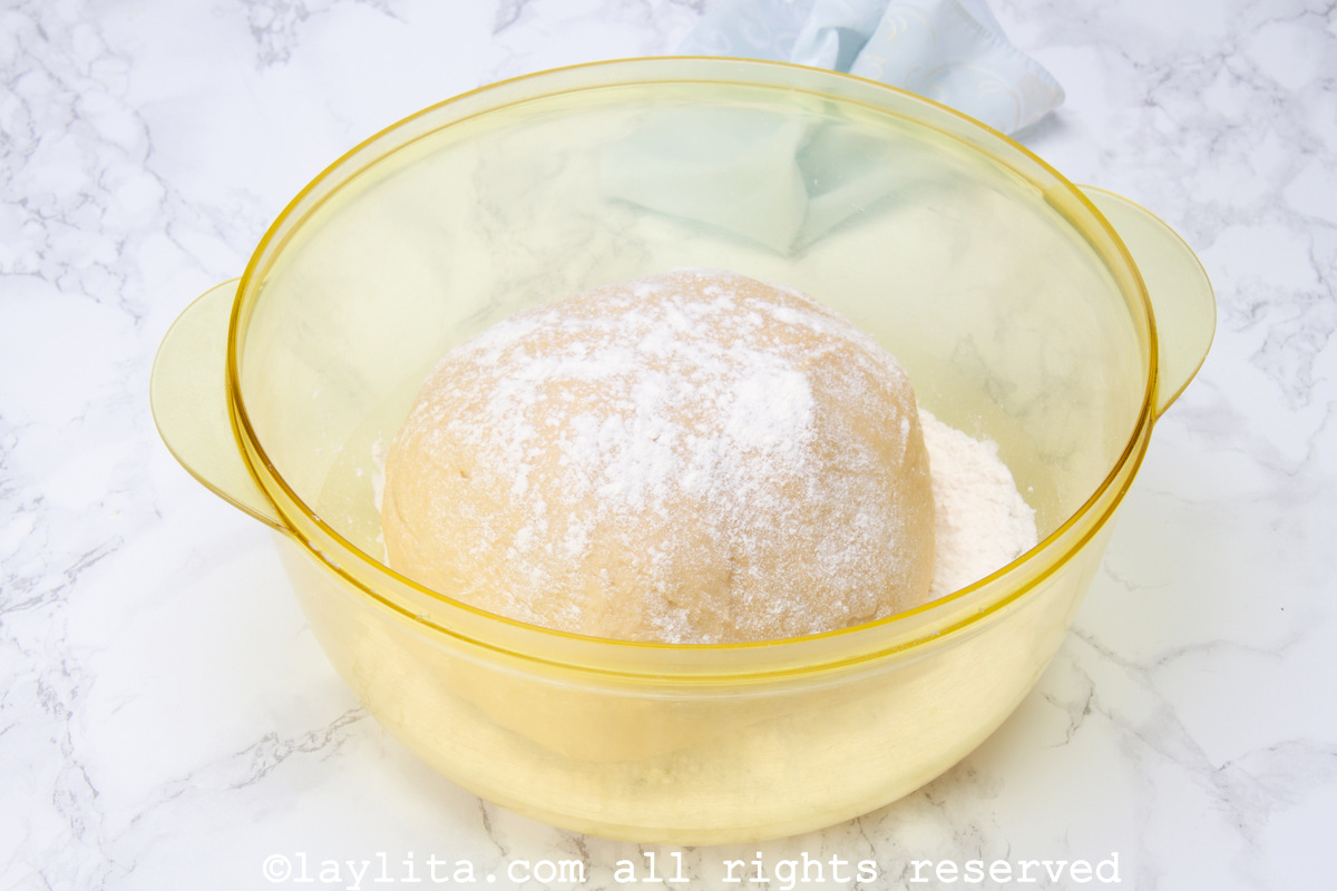 Ball of dough in a bowl with four sprinkled on top.