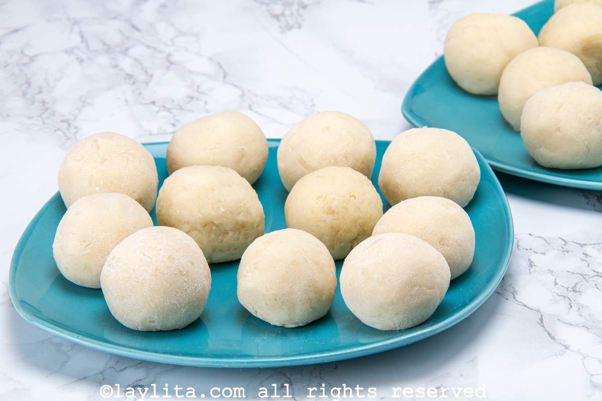 Buñuelos assembled and placed on a blue plate before being fried.
