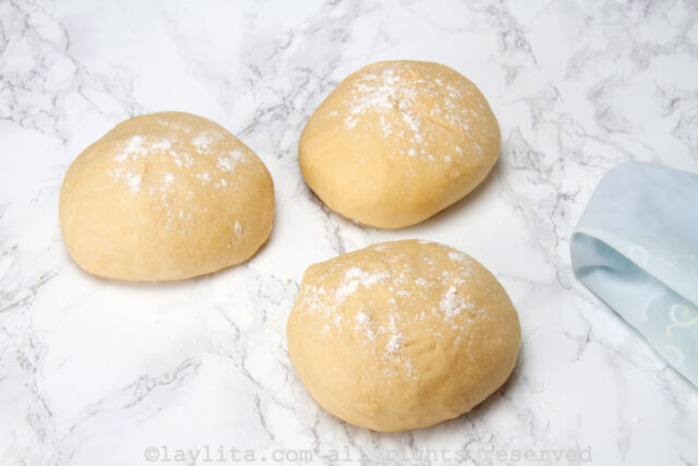 3 balls of dough on a floured surface
