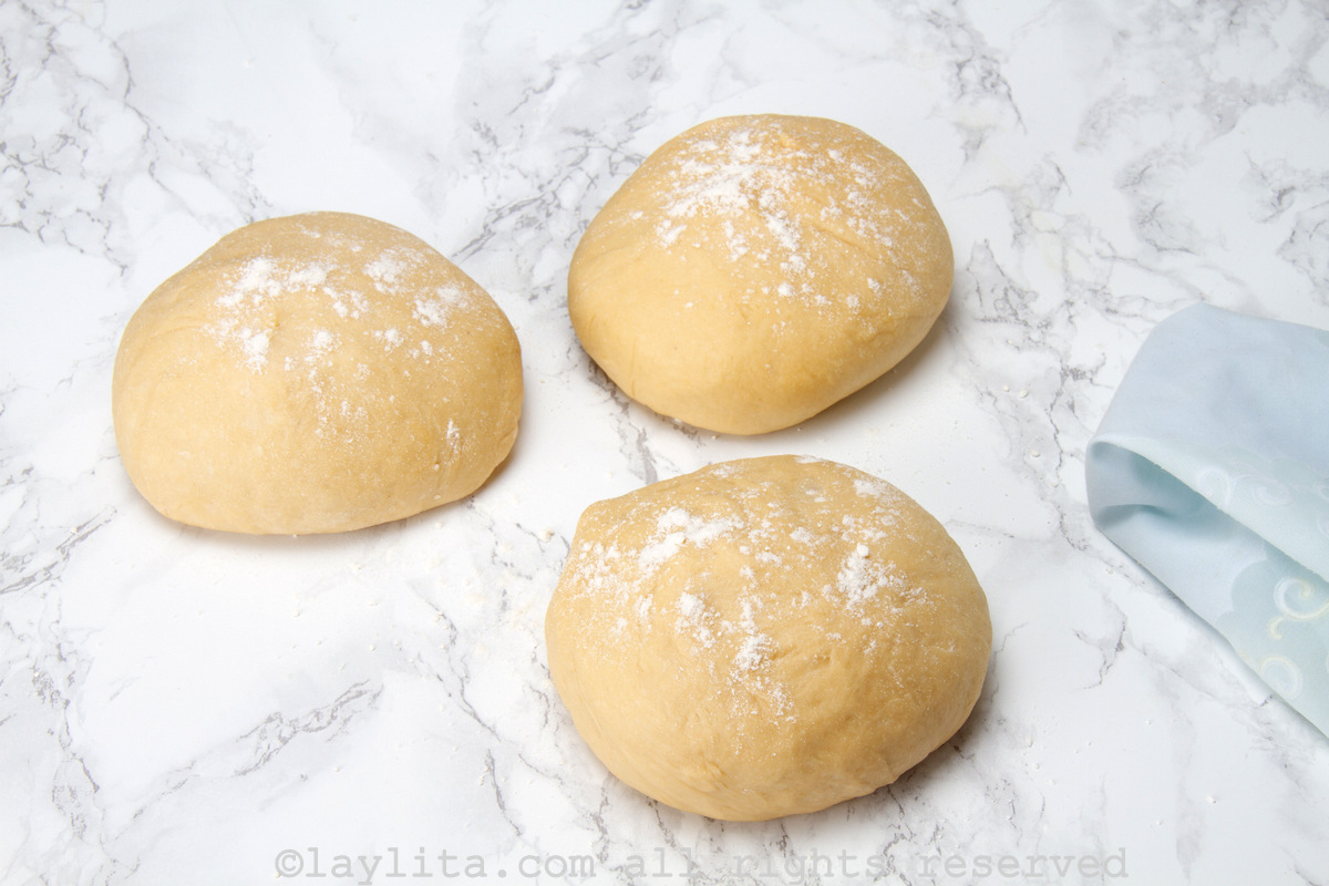 3 balls of dough on a floured surface