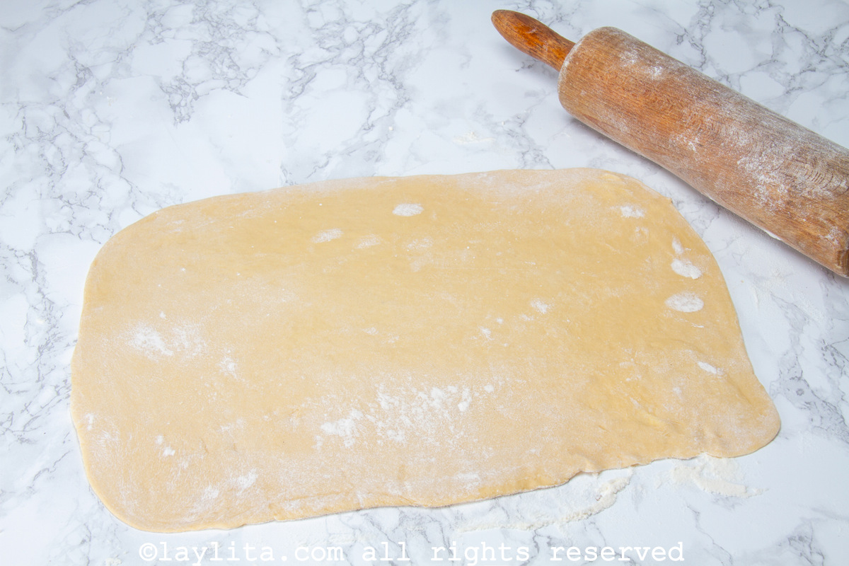 Dough rolled into a rectangle on a counter.