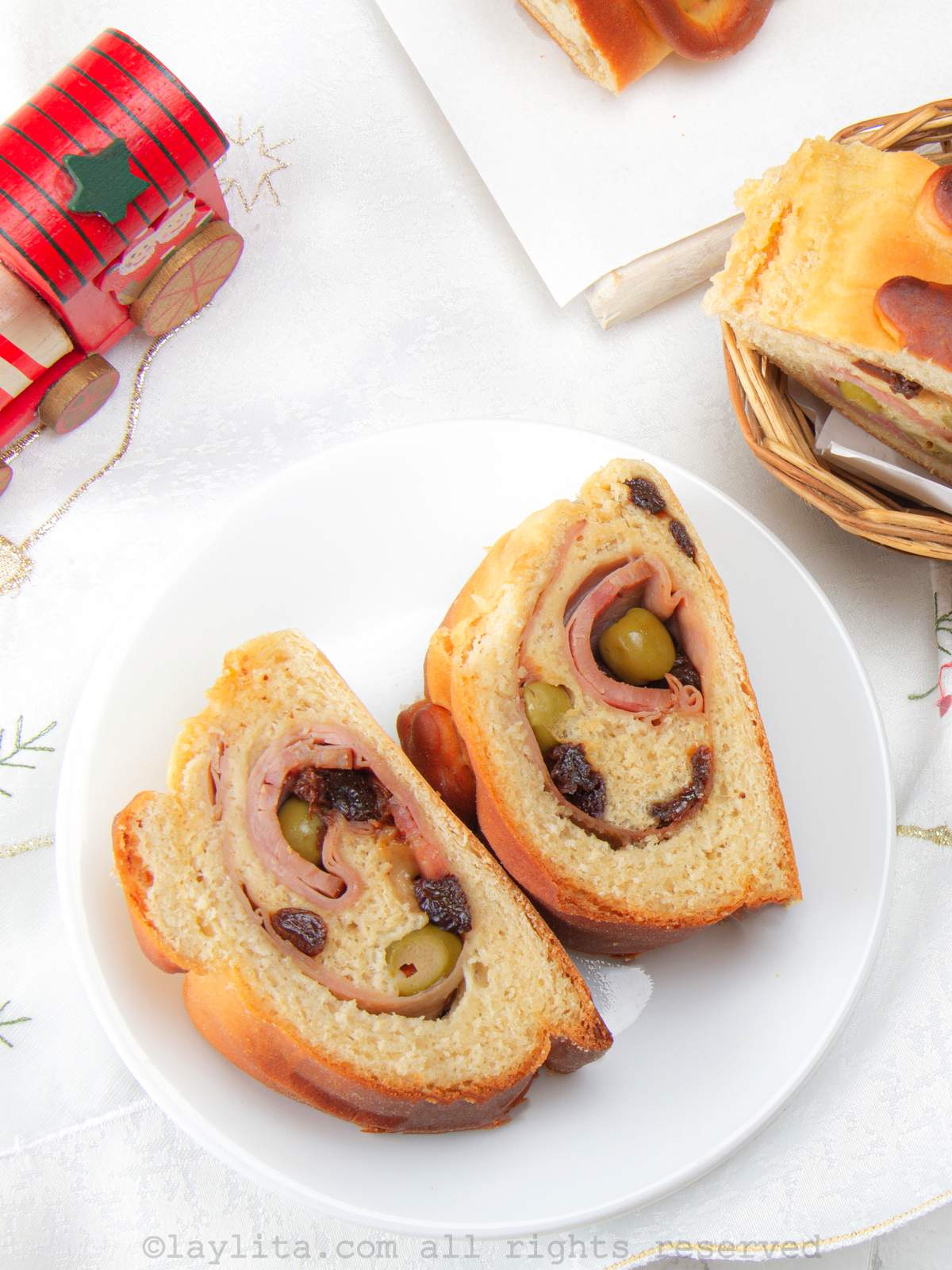 Overhead shot of two slices of pan de jamón on a white plate.