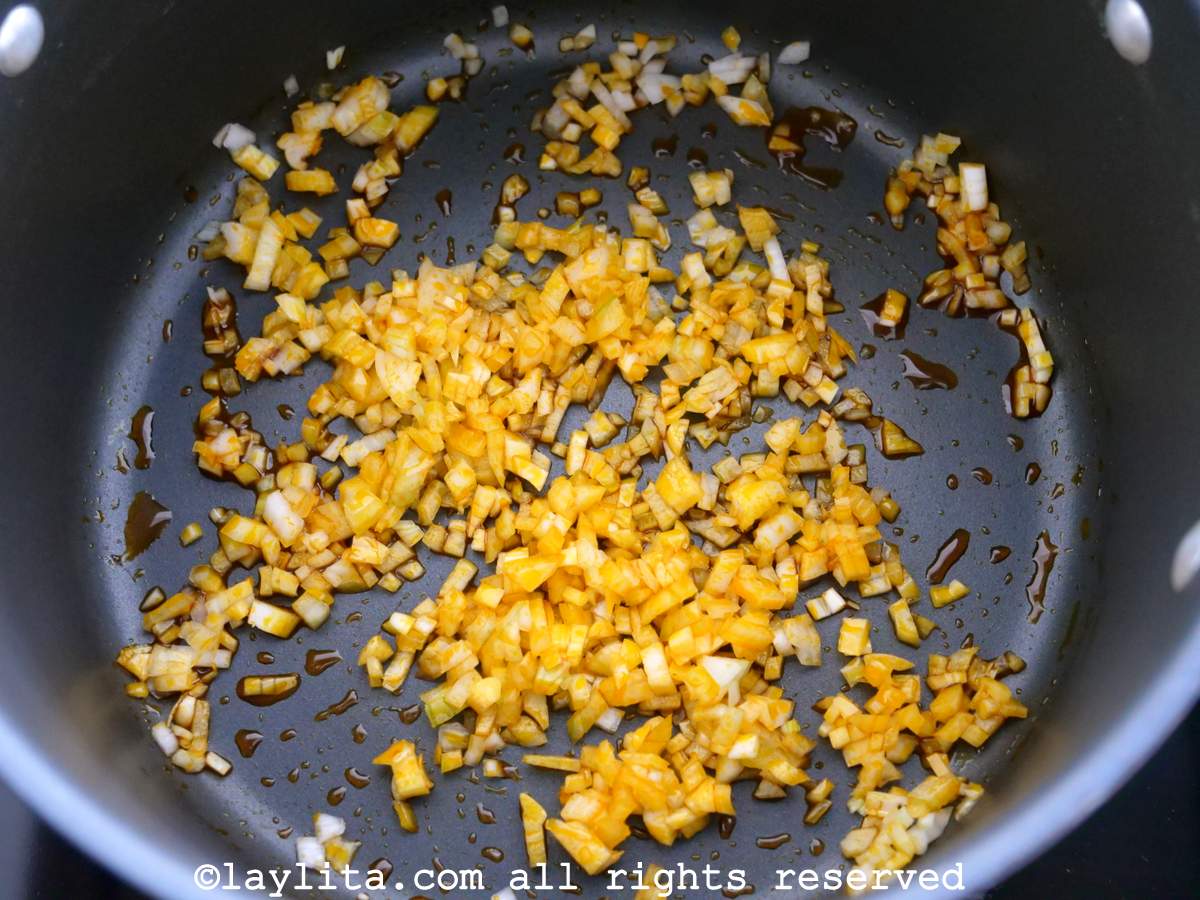 Onions with achiote oil cooking in a pot