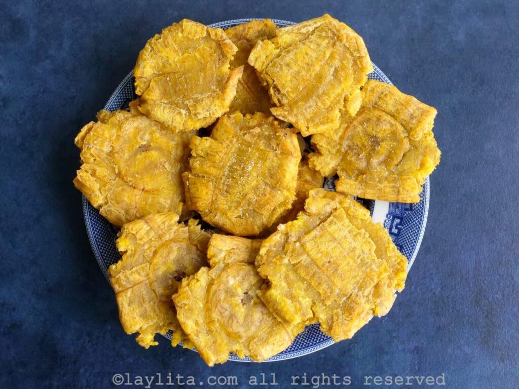 Plate full of patacones or thick green plantain chips
