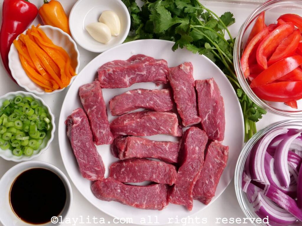 Ingredients for Peruvian lomo saltado on a white table