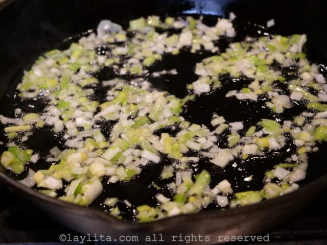 Onions and garlic cooking in a skillet