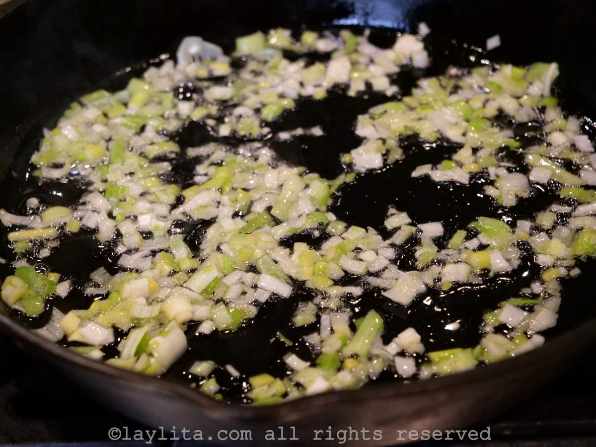 Onions and garlic cooking in a skillet