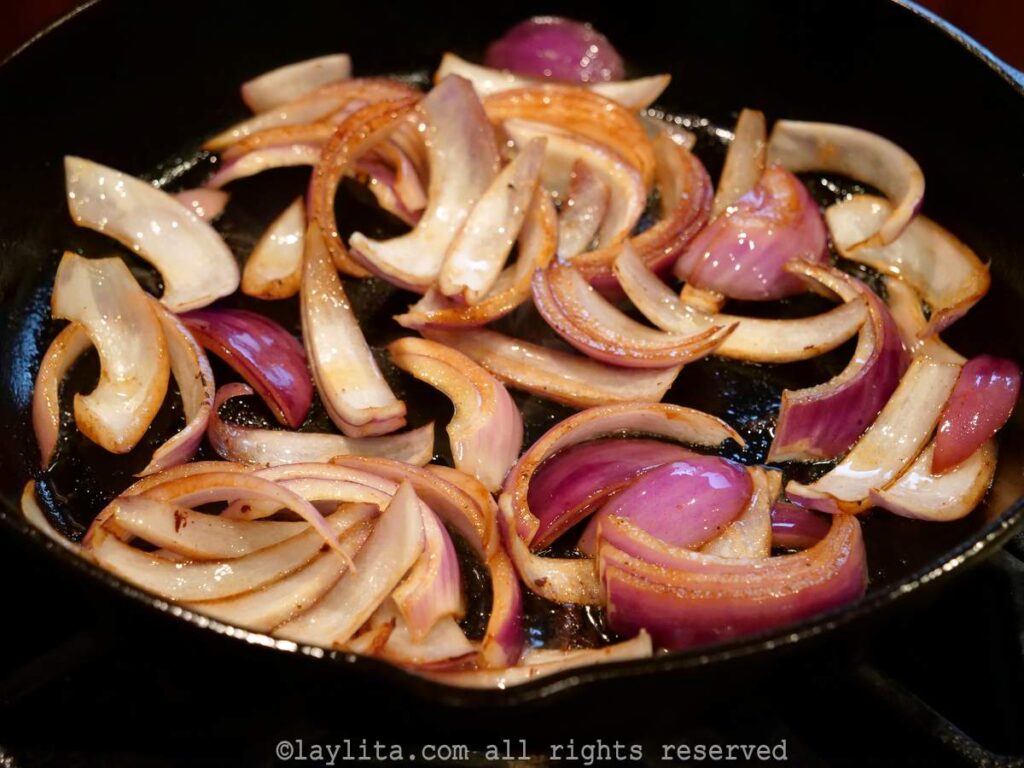 Onions with a golden color in a pan.