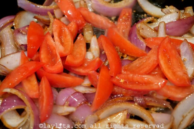 Tomato wedges added to the pan.