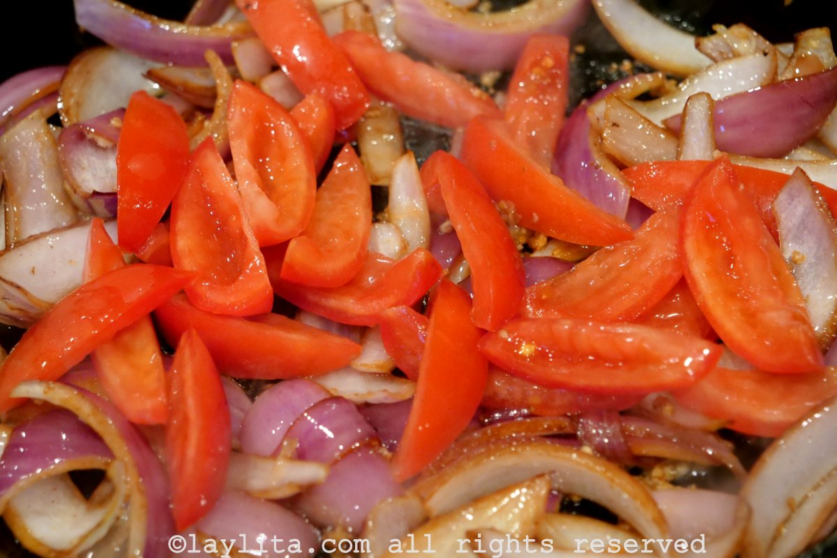 Tomato wedges added to the pan.