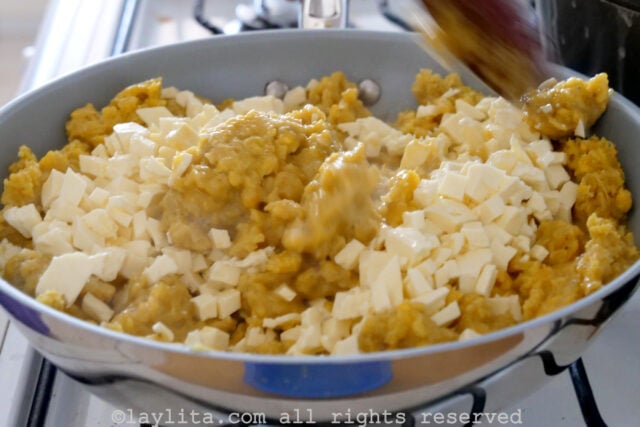 Cubes of cheese added into the pan with the plantains.