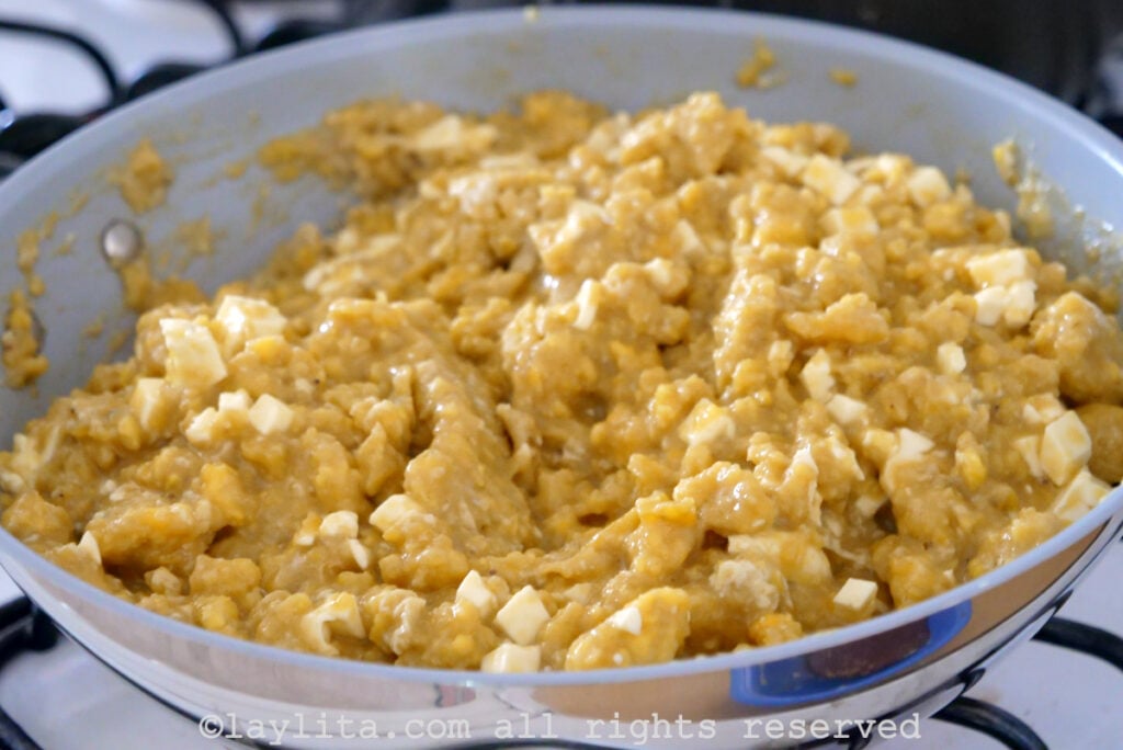 Mashed green plantains and cheese cooking a pan