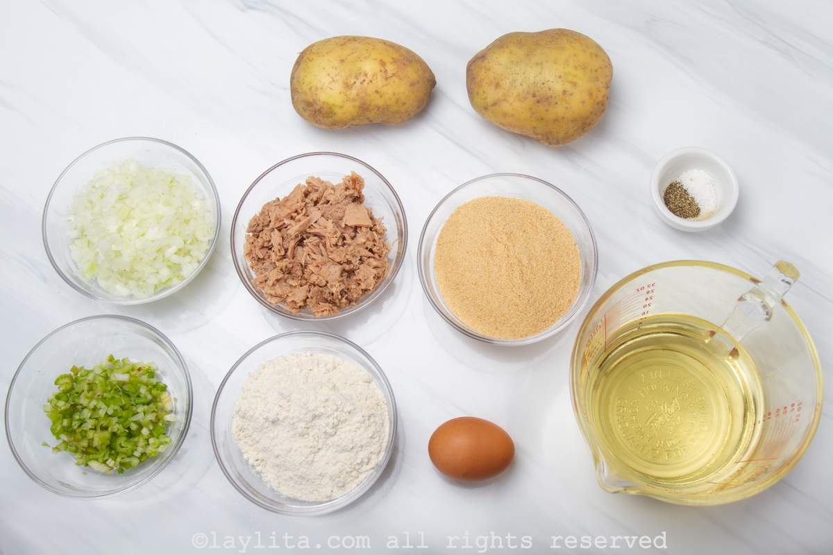 Ingredients needed for tuna croquettes on a white surface