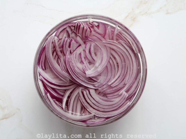 Soak the sliced red onions in cold water to remove the bitterness