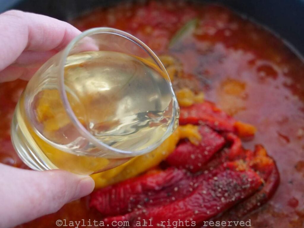 Adding white wine to the bacalao