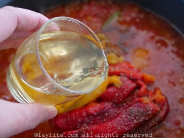 Adding white wine to the bacalao