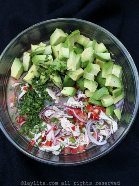 Adding diced avocado, rest of the cilantro and oil to the ceviche mix
